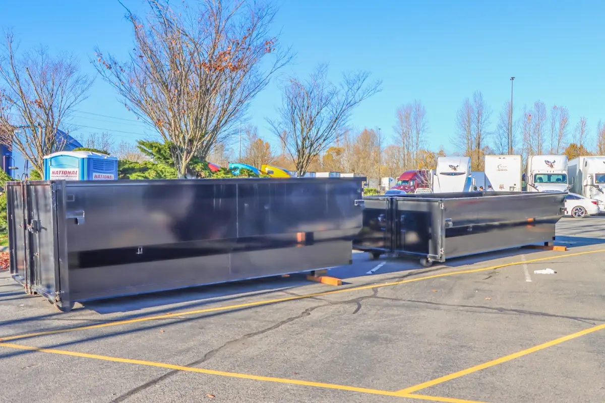 Professional dumpster rental service with roll-off container on residential driveway in Chandler